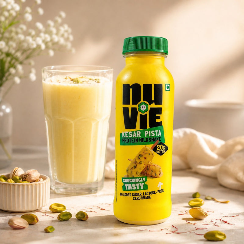 Nuvie Kesar Pista Protein Milkshake bottle with a glass of kesar pista milkshake