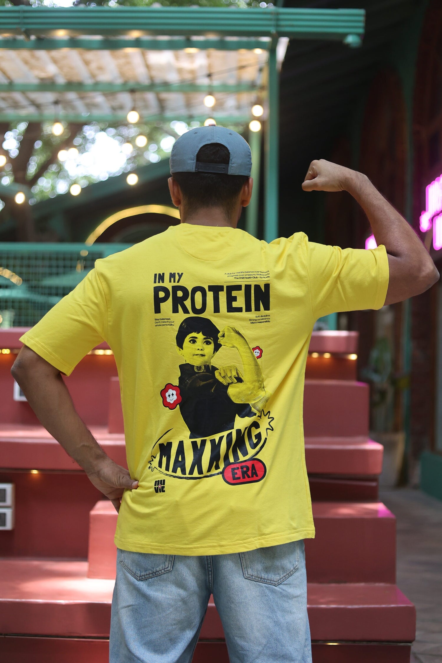 In My Protein Maxxing Era oversized tee - Parle-G Girl graphic, back view on model flexing